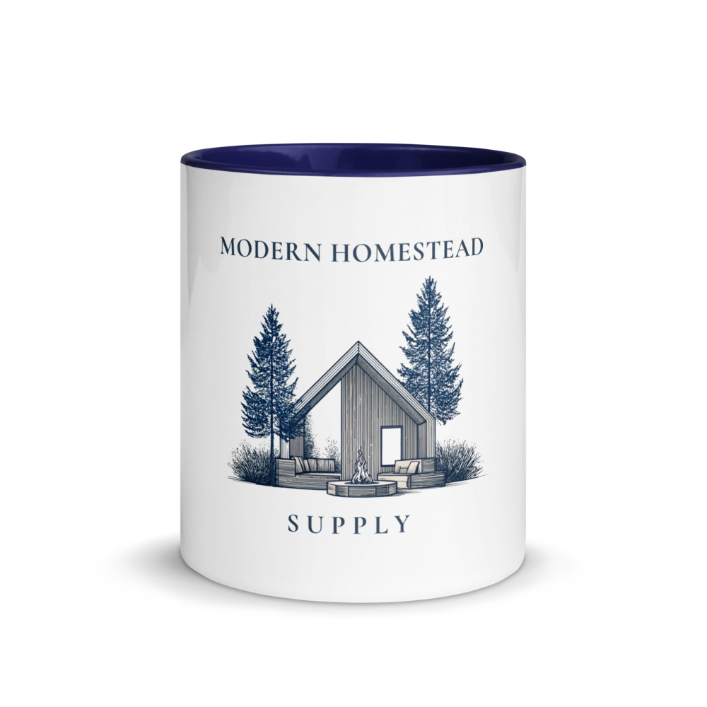 Mug with 'Modern Homestead Supply' design featuring a cabin and trees on a white background.
