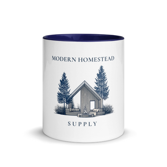 Mug with 'Modern Homestead Supply' design featuring a cabin and trees on a white background.
