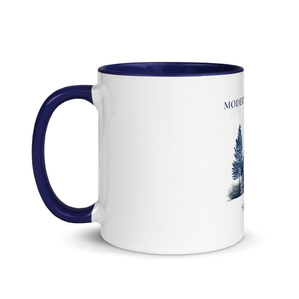 White mug with blue handle and interior, featuring a nature-themed design on a white background